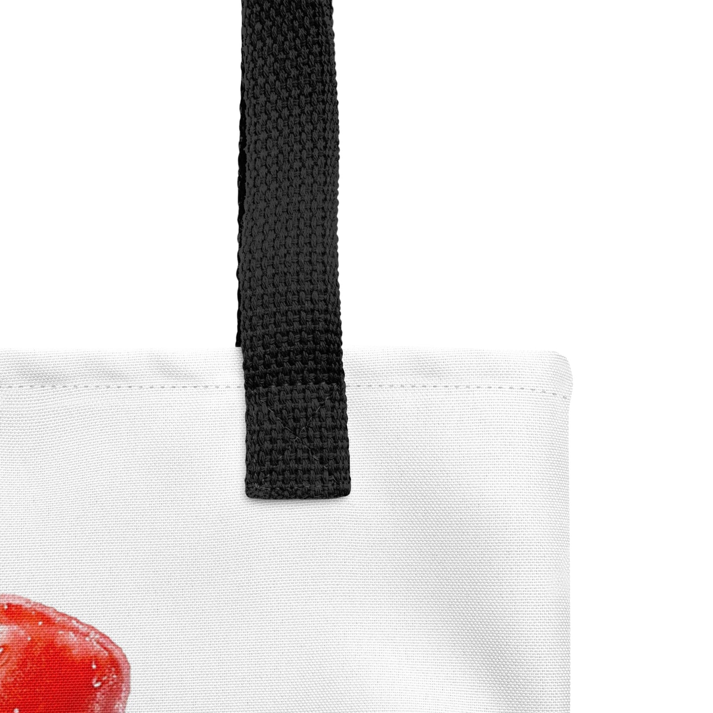 Close-up of a white tote bag with a black woven handle and popsicle design