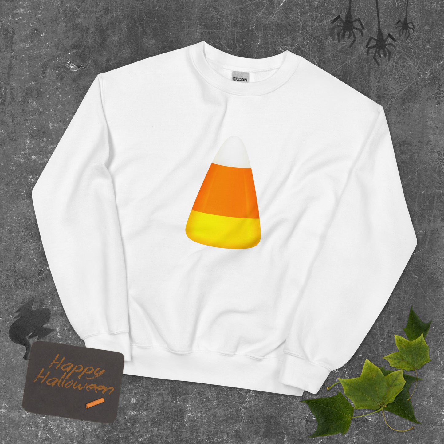 A white crewneck sweatshirt featuring a candy corn graphic for Halloween Trick or Treat