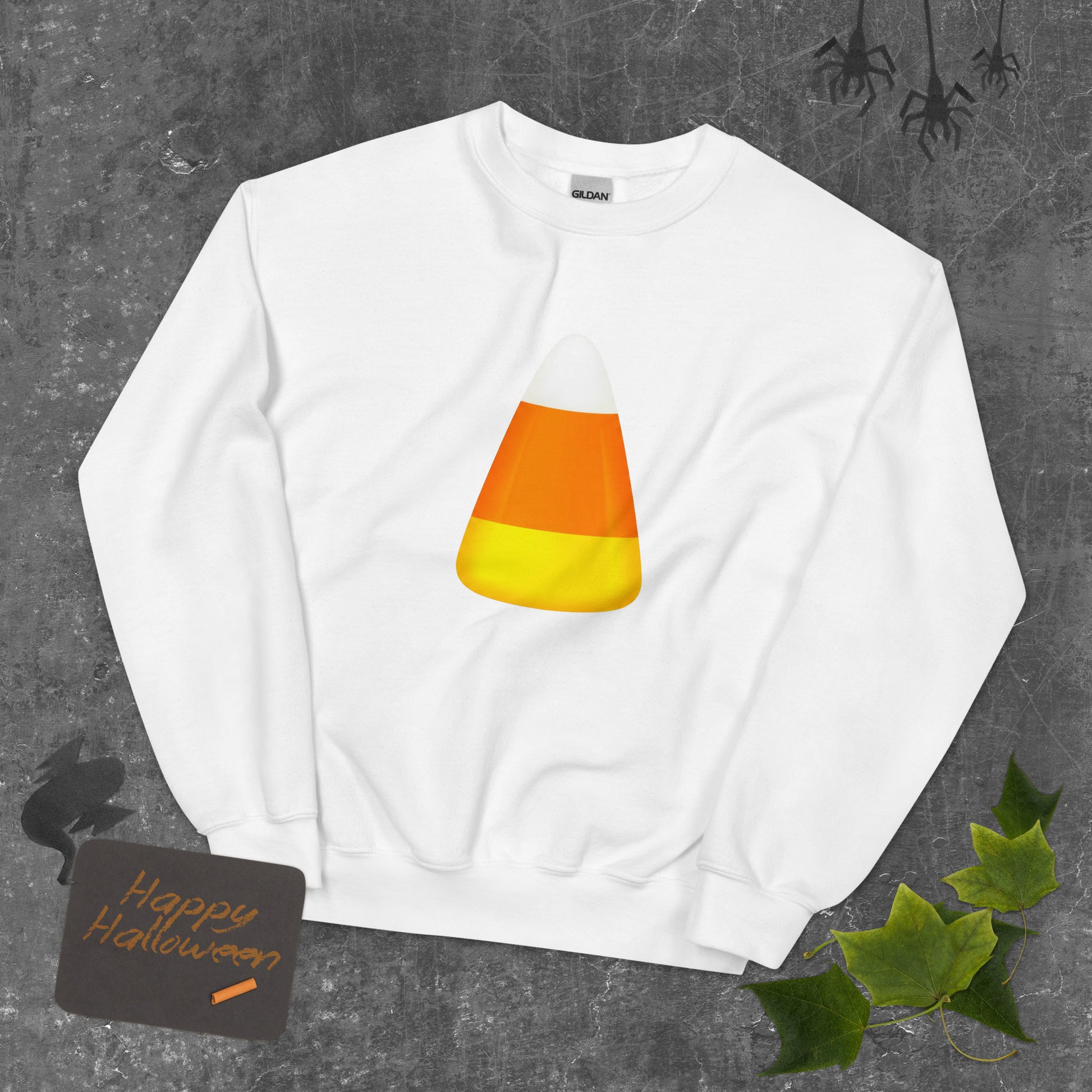 A white crewneck sweatshirt featuring a candy corn graphic for Halloween Trick or Treat