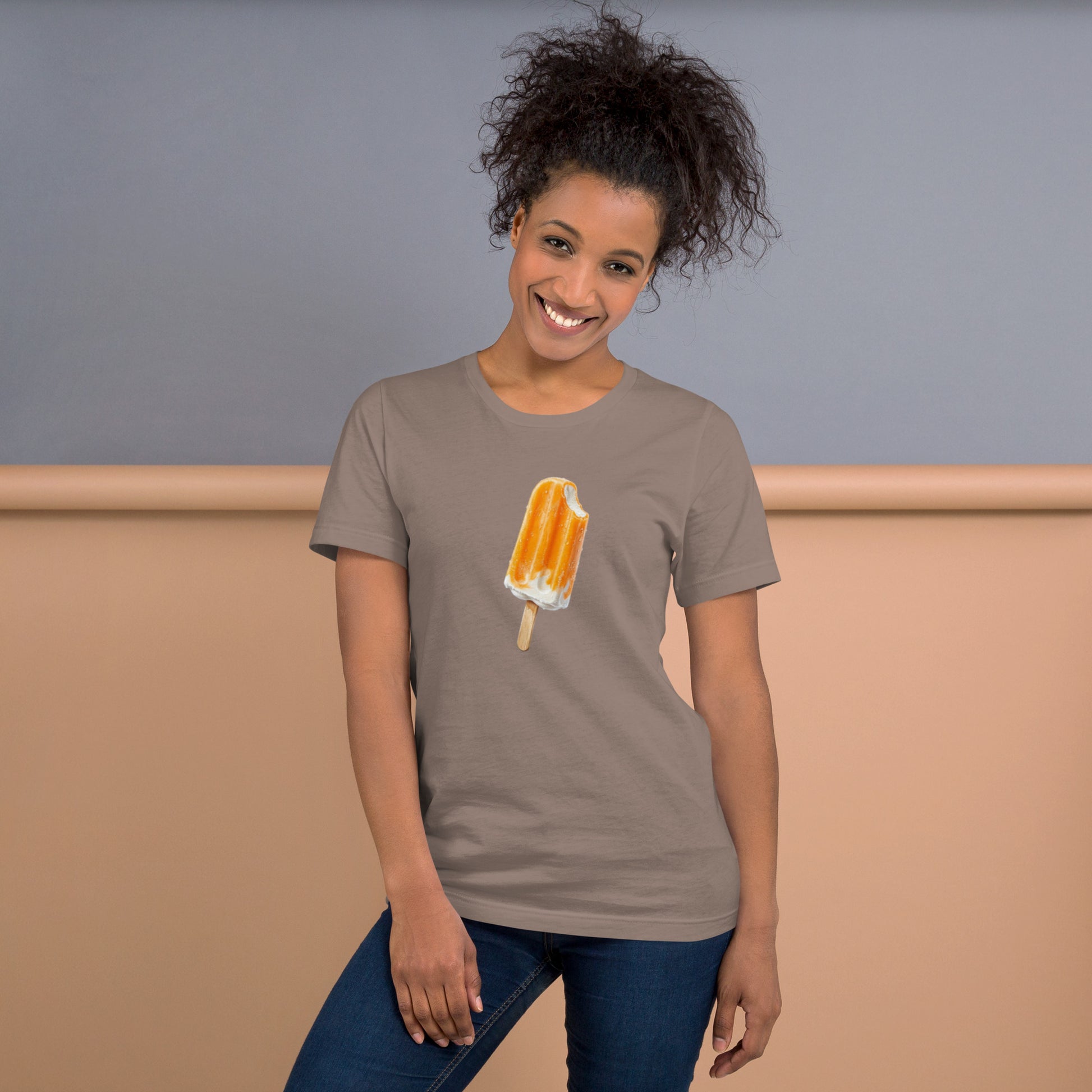 Woman's  light brown pebble color t-shirt with an orange cream popsicle