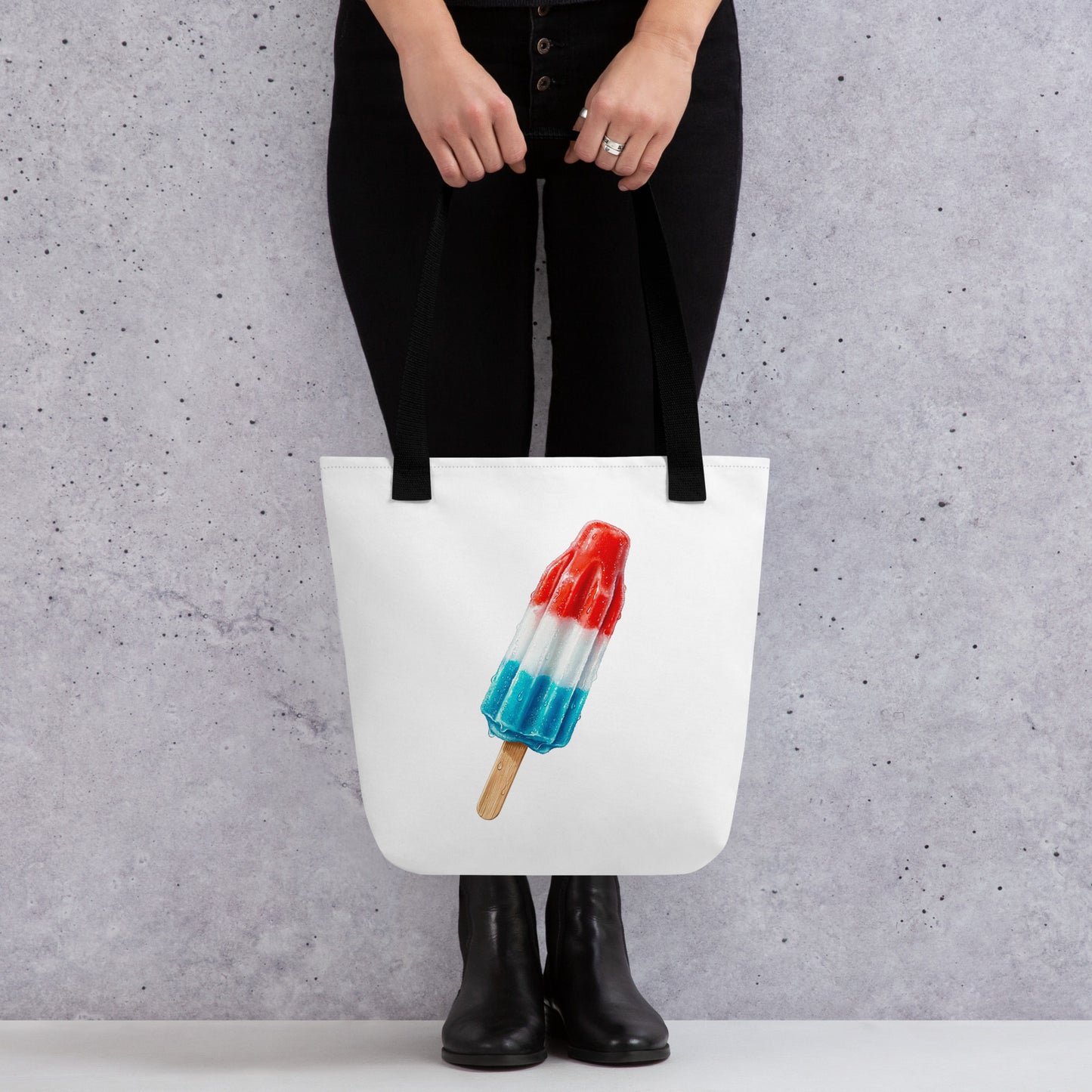 White tote bag with black handles, featuring a graphic of a red, white, and blue popsicle 
