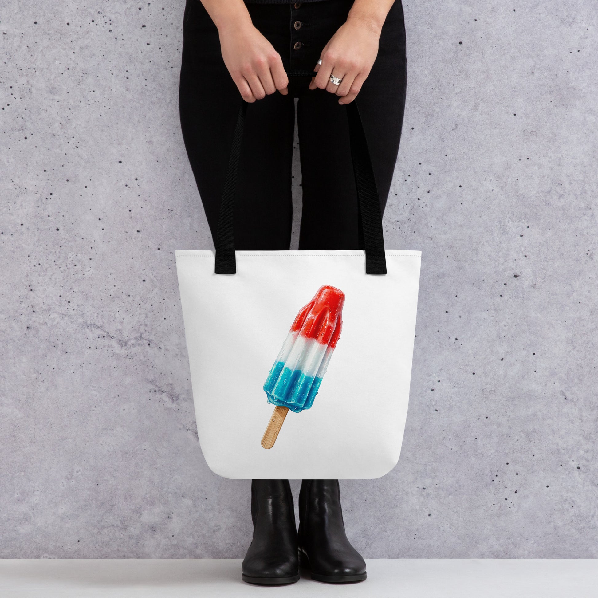 White tote bag with black handles, featuring a graphic of a red, white, and blue popsicle 